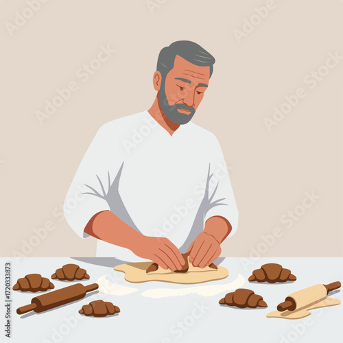 Baker preparing croissants by rolling the dough at a table
