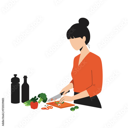 Woman with hair bun chops veggies with knife on a cutting board for a meal