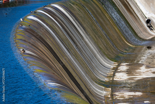 water flowing over dam