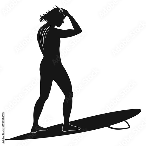 Surfer wiping hair after wave silhouette