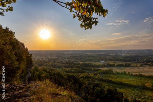 Beautiful sunset view from Mt. Nemo in Burlington, Ontario, showcasing a stunning landscape of fields, forests, and a radiant sky.