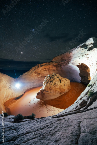 Night scene of unique rock formations illuminated under a starry sky