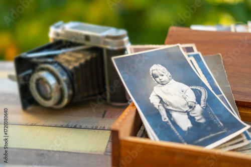 Obraz na plátně vintage black and white photo baby family archive, wooden box and retro film cam