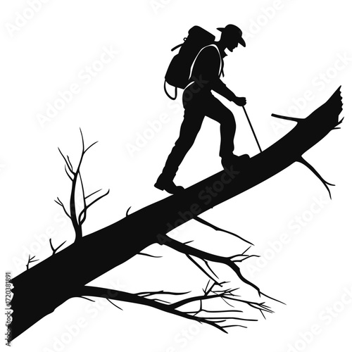 Hiker crossing fallen tree silhouette