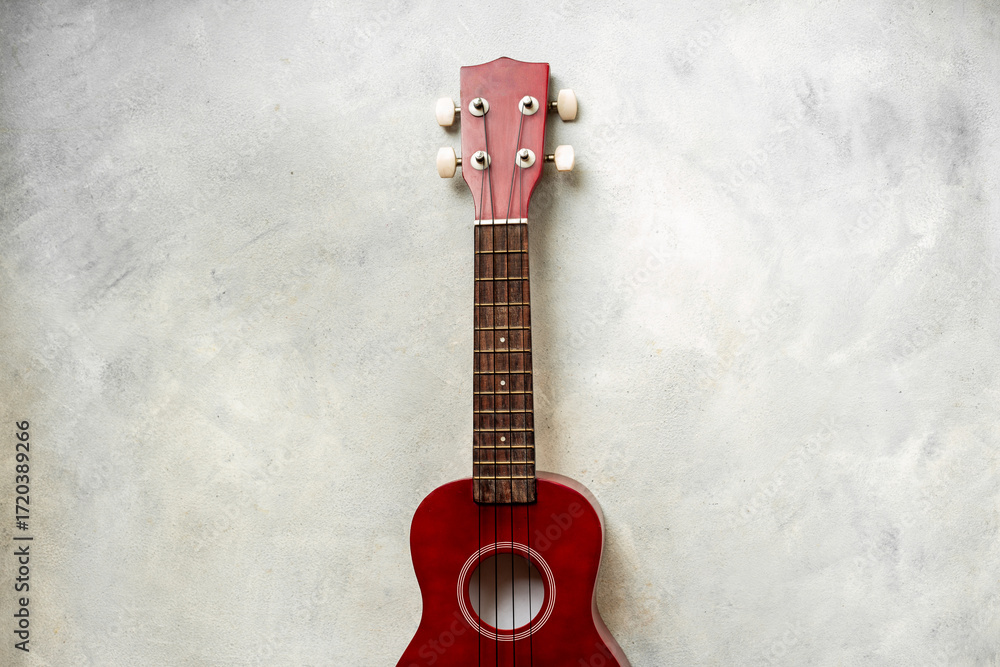 Naklejka premium Brown red four string ukulele small guitar. Musical instrument, top view
