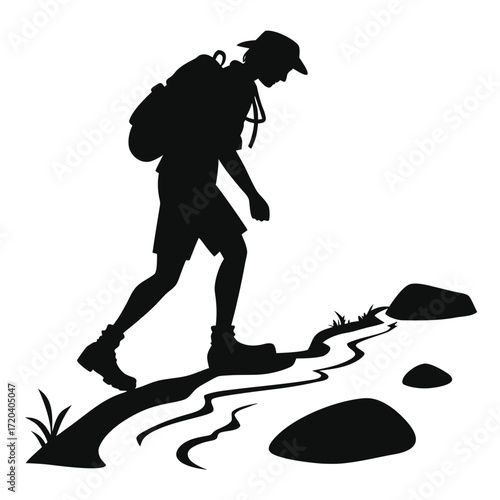 Hiker stepping over stream silhouette