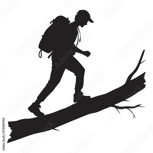 Hiker climbing over fallen log silhouette