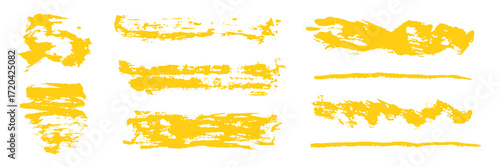 Artistic set of grunge hand painted isolated bright mustard yellow ink textured brush strokes. Unique abstract crayon pencils drawing squiggles, scribble and scratches for graphic design