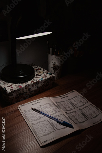 Sudoku Puzzle Book with Pen on Desk