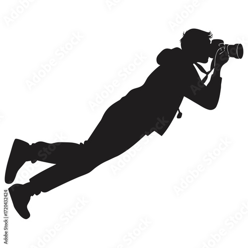 Photographer lying to capture macro shot silhouette