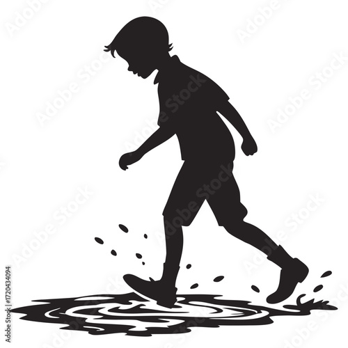 Boy splashing in puddle silhouette