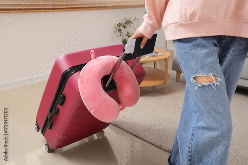Young woman with suitcase, ...