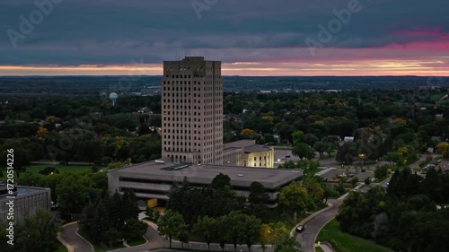 A beautiful sunset illuminates the north dakota state capitol in bismarck
