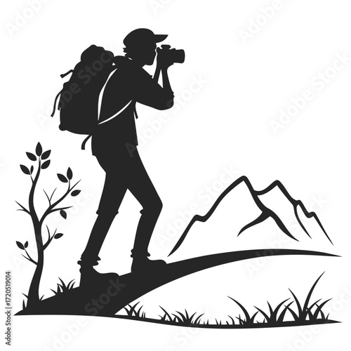 Backpacker photographing landscape silhouette