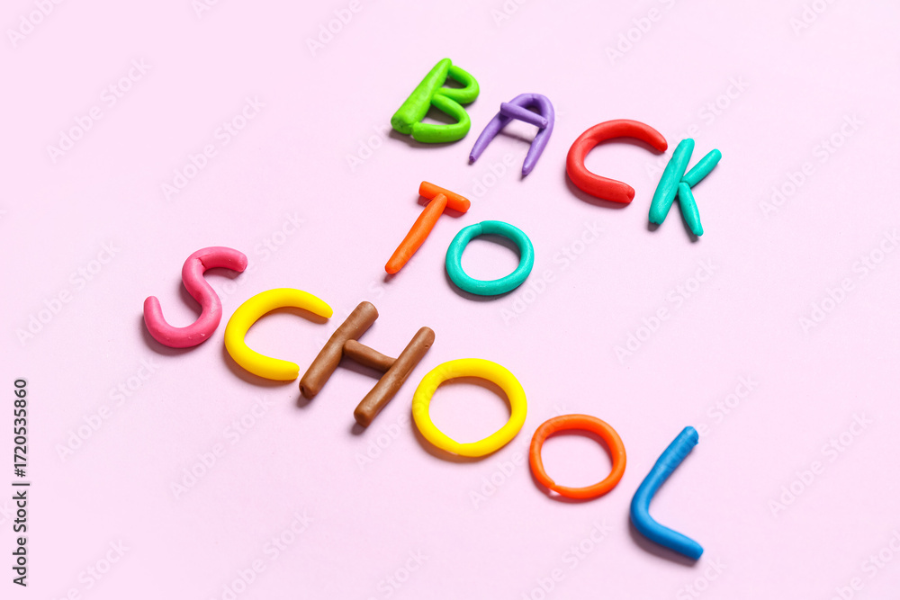 Fototapeta premium Text BACK TO SCHOOL made of play dough on pink background