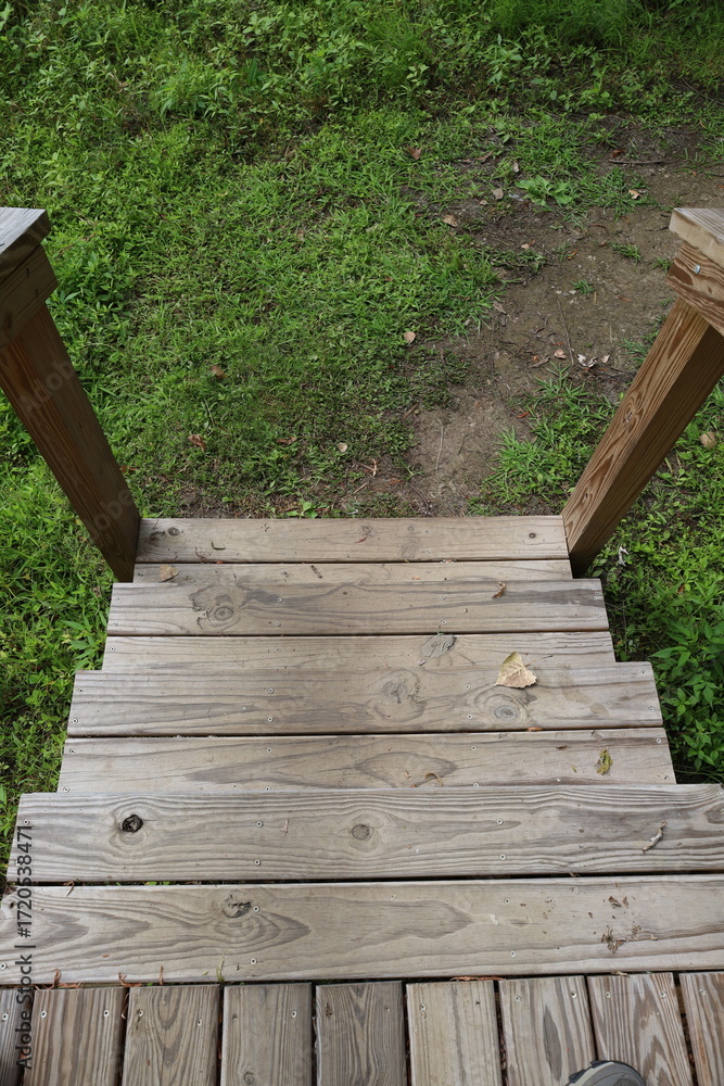 Obraz premium Steep view down wooden outdoor steps descending vertical photo