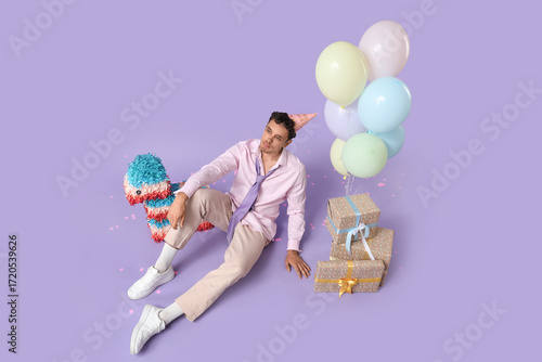 Sad young man with pinata a...
