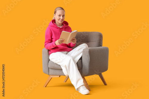 Young woman reading book in...