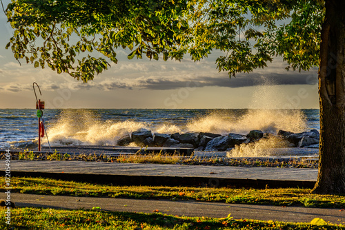 Photography Dramatic breaking waves with empty bike path and boardwalk in foreground shot ea