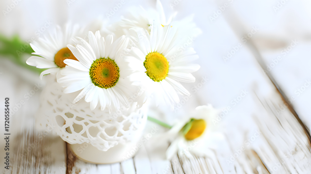 Obraz premium Fresh daisies in a simple white vase, radiating natural charm and understated elegance.