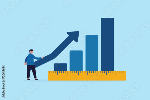 Man points to upward trending bar graph supported by a ruler indicating growth and success