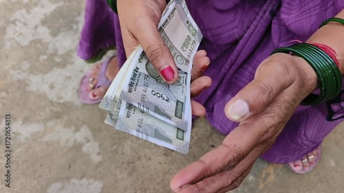 Indian female counting 500 rupees Indian currency notes	
