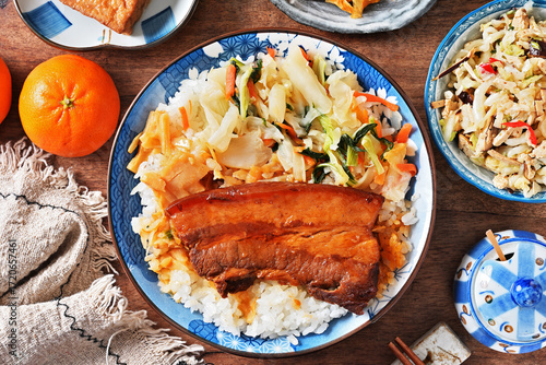 Braised pork belly rice is a beloved Taiwanese dish featuring a thick slice of soy-braised pork belly served over steamed white rice.