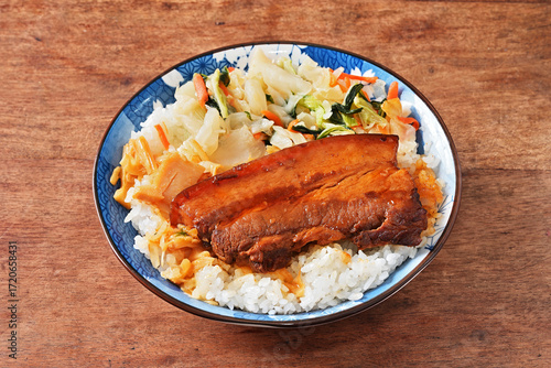 Braised pork belly rice is a beloved Taiwanese dish featuring a thick slice of soy-braised pork belly served over steamed white rice.
