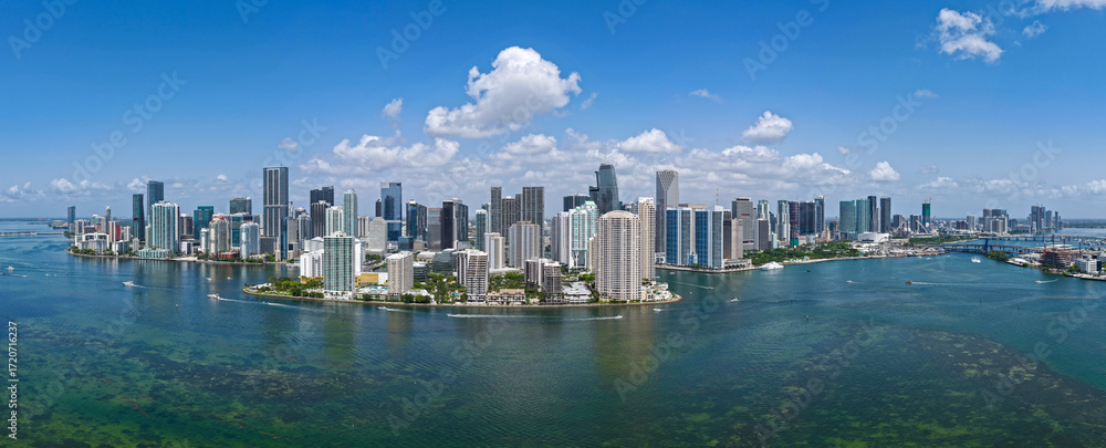Obraz premium Aerial panorama of Brickell in Miami. Downtown Miami skyline on a sunny day. Scenic view of Miami Beach and Brickell. Brickell famous landmarks. Miami downtown landscape.
