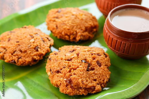 Parippu Vada or Paruppu Vadai made with toor dal. Kerala fried snacks savory food on banana leaf on dark black background. Kerala tea time food fried in coconut oil. Top view of South Indian snacks.
