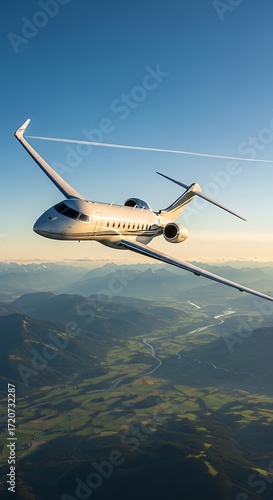 A private jet soars above a valley, showcasing scenic mountain views.