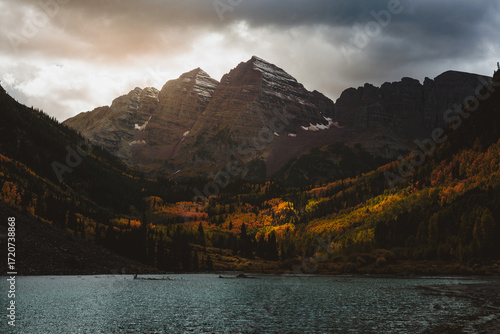 Scenic Maroon Bells Aspen Colorado autumn fall sunset vibrant trees golden hour leaves mountain peaks dramatic clouds tranquil lake reflection nature wilderness landscape outdoor photography travel