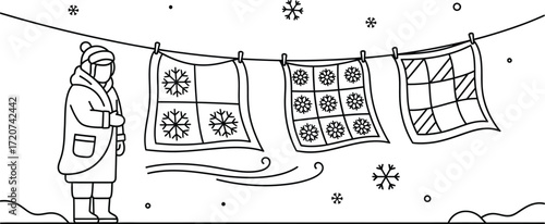 Woman hanging up quilts on a clothesline in winter