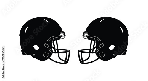 Two black football helmets facing each other ready for competition and game day sports action isolated on white background