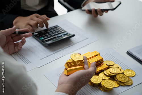 Businessmen discuss investing in gold bars and stocks