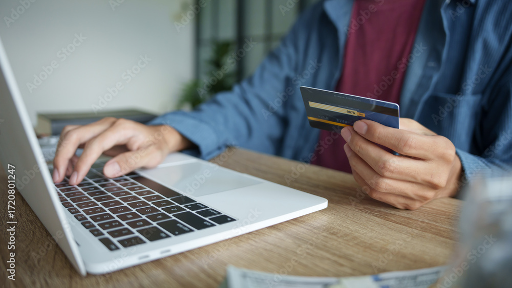 Fototapeta premium Businessman hold credit card online payment in laptop.