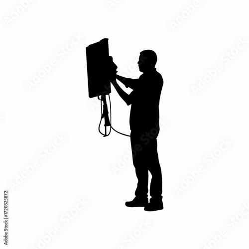 Silhouette of it worker adjusting monitor cables on white background silhouette