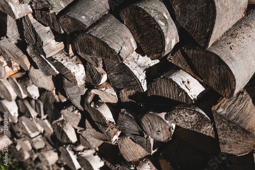 Stack of firewood logs with natural texture, rustic detail and organic wooden background for eco and vintage themes.