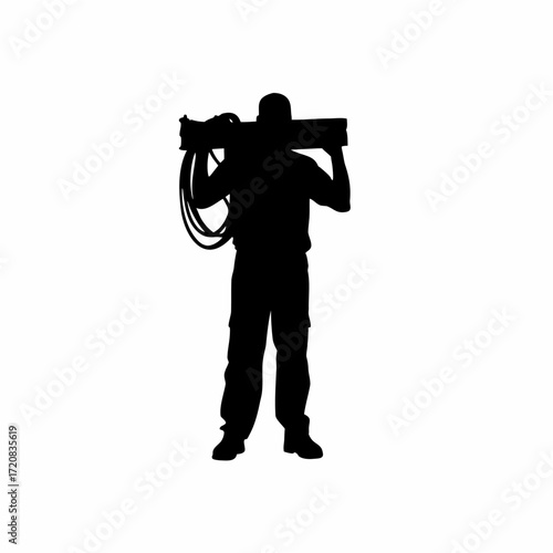 Silhouette of technician carrying network cables in server room