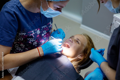 Young patient receives dental treatment in a modern clinic setting during daylight hours