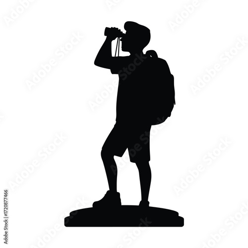 Silhouette of a hiker with backpack and binoculars