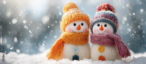 Wallpaper Mural two cute snowmen in colorful hats and scarves, standing on the white snow with a pick background,  Torontodigital.ca