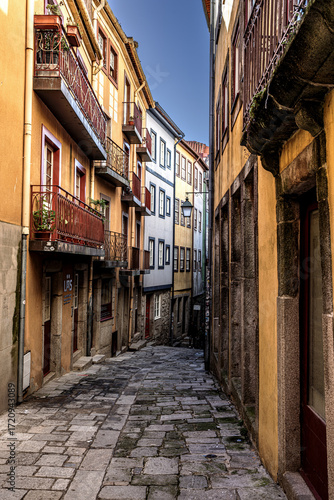 Narrow alley with colourful facades in the old town of Porto, Portugal.
