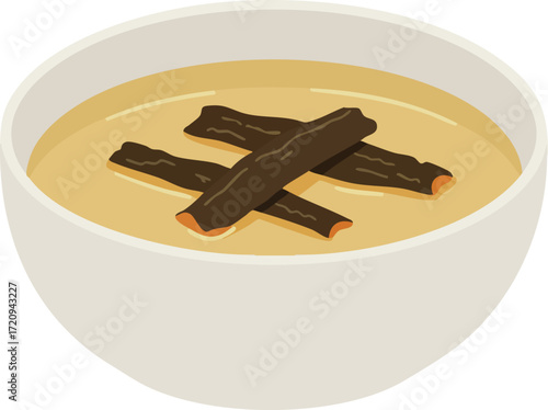 A bowl of creamy yellow soup with dark brown sticks on top.