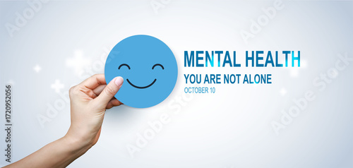 World Mental Health Day concept with hands holding happy smile face symbol, promoting support, awareness, positivity and emotional wellbeing, you are not alone.