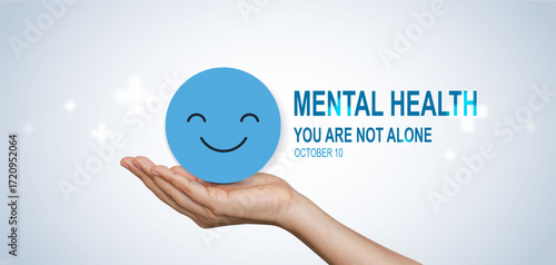 World Mental Health Day concept with hands holding happy smile face symbol, promoting support, awareness, positivity and emotional wellbeing, you are not alone.