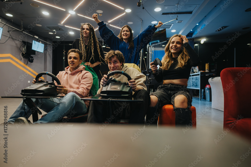 Obraz premium A close group of young friends enthusiastically participating in a video gaming experience in an arcade environment, capturing joy, friendship, and teamwork while engaging in a racing simulator game.