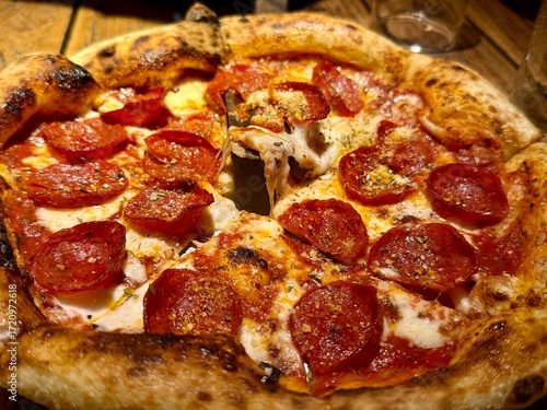 Pepperoni pizza on a wooden cutting board