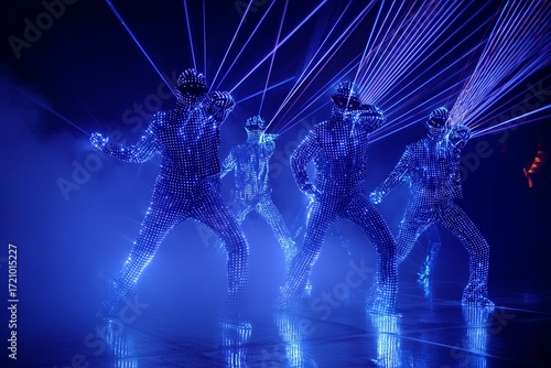 Dancers in illuminated suits performing in a dazzling laser light display