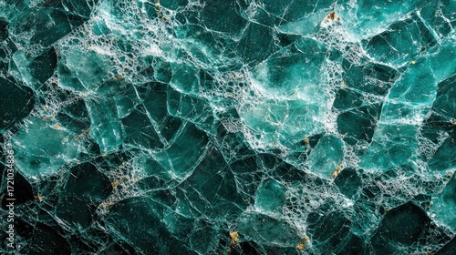 Fracture pattern in translucent, deep teal, crystalline mineral structure